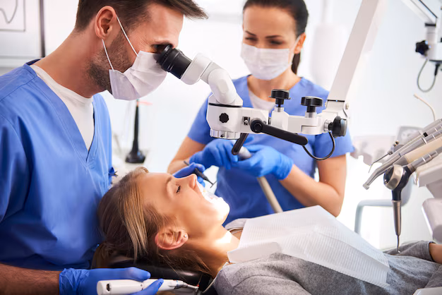 male dentist working with dental microscope 329181 20732